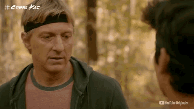a man wearing a headband talks to another man in a youtube originals advertisement