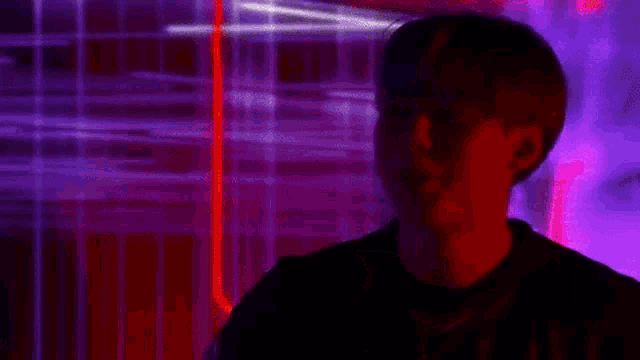 a man is standing in front of a screen with a reflection of a woman 's face on it .
