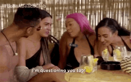 a group of people are sitting at a table and one of them says i 'm questioning you too .