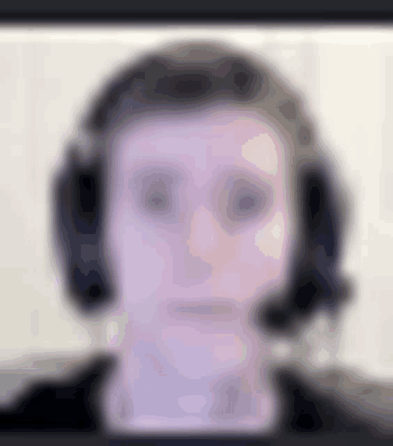 a blurry picture of a man wearing headphones and a headset .