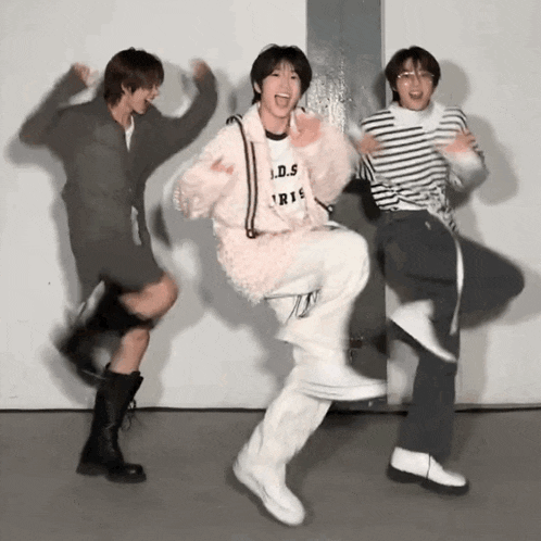 three people are dancing with one wearing a shirt that says l.d.s. paris