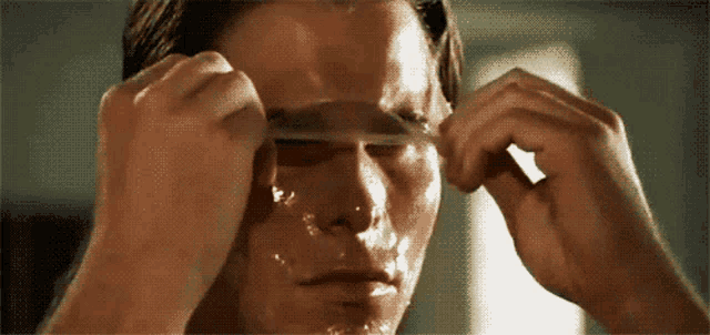 a close up of a man 's face with a spoon in it