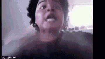 a woman is making a funny face while talking on a video call with her mouth open .