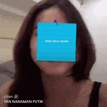 a woman 's face is obscured by a blue sticky note that says 100k face reveal