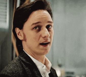 a man in a suit and white shirt is making a surprised face