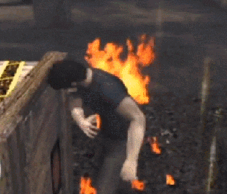 a man is standing in front of a fire in a dark room