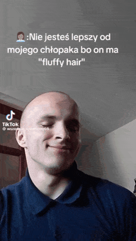 a man in a blue shirt is smiling in a tik tok video