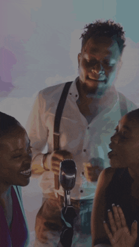 a man is holding a microphone in front of a woman