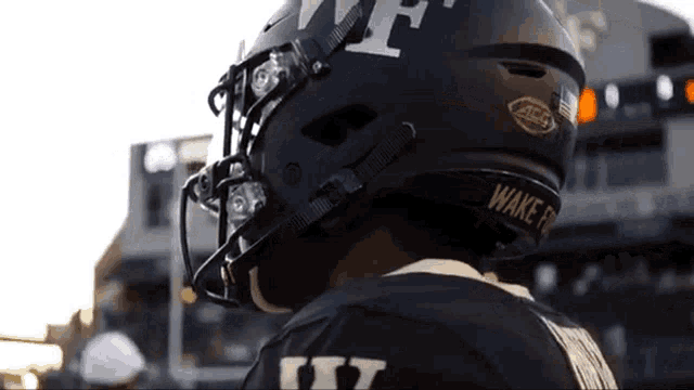 a football player wearing a black helmet that says wake forest