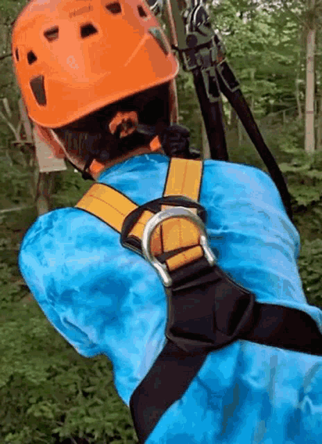 a person wearing a blue shirt and an orange helmet