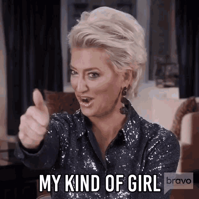 a woman is giving a thumbs up and saying my kind of girl bravo