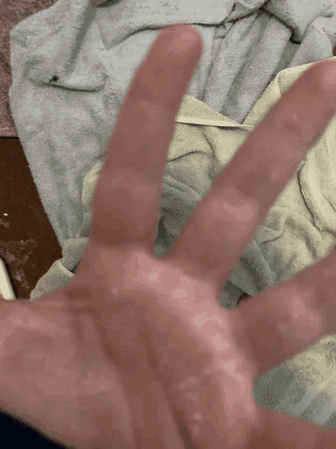 a close up of a person 's hand with their fingers spread out