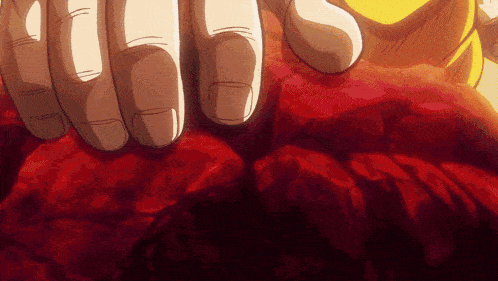 a close up of a person 's hand on a red object