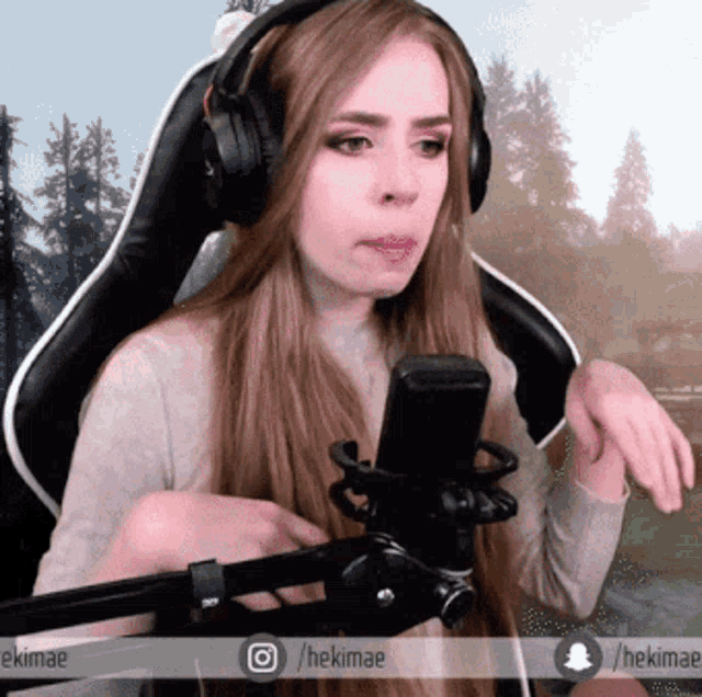 a woman wearing headphones and a microphone has the hashtag hekimae