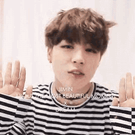 a young man wearing a black and white striped shirt with the words jimin about the most beautiful moment x dream
