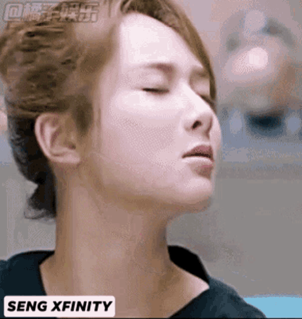 a close up of a woman 's face with the words seng xfinity on the bottom left