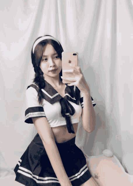a girl is taking a selfie with her iphone