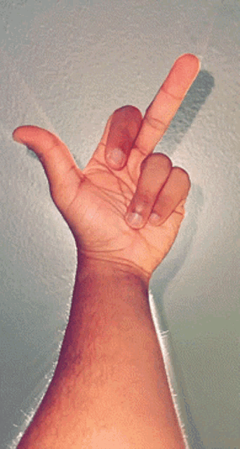 a hand is making a middle finger sign
