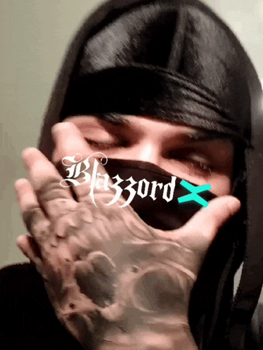 a man covering his face with a mask that says blizzard
