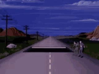 a couple of people standing on the side of a highway