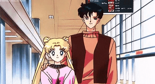 a man and a girl are standing next to each other in an airport