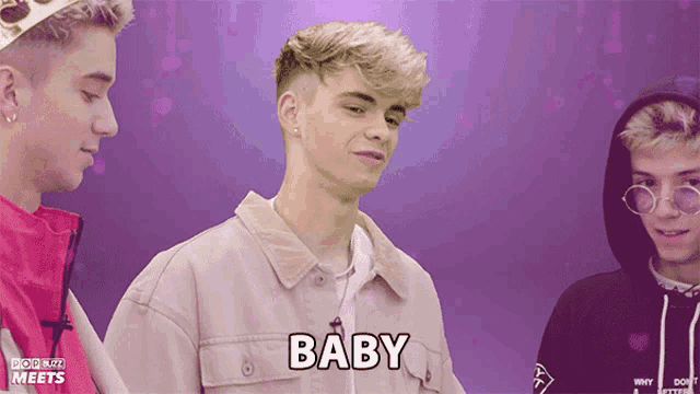 a young man with the word baby written on his shirt