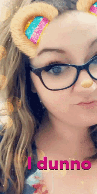 a woman wearing glasses and bear ears says i dunno in pink