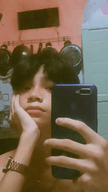 a person taking a picture of themselves with a phone that says oio