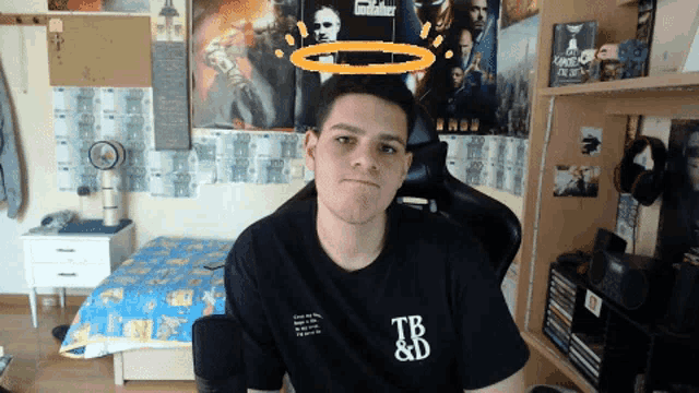 a young man wearing a black tb and b shirt