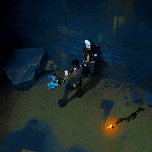 a man holding a sword in a dark room with a purple light coming out of the ground