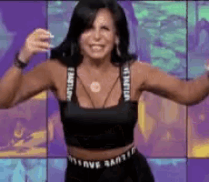 a woman wearing a black crop top and black shorts is dancing