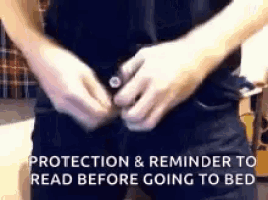 a person is putting on a pair of black pants and a reminder to read before going to bed