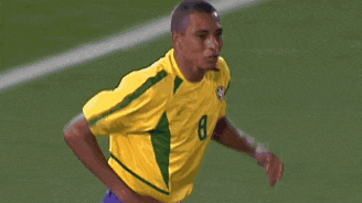 a soccer player wearing a yellow and green jersey with the number 8 on it