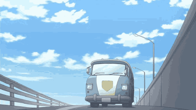 a blue van with a yellow shield on the front is driving down a bridge