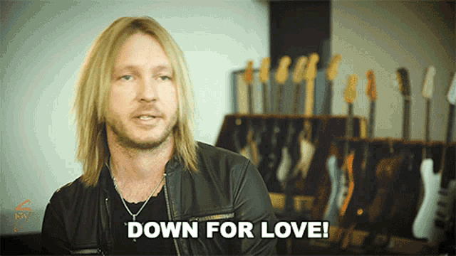 a man with long blonde hair and a beard says down for love