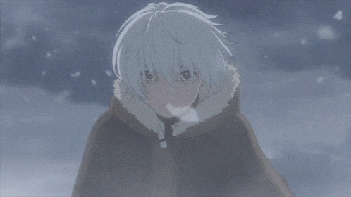 a young boy with white hair is standing in the snow .