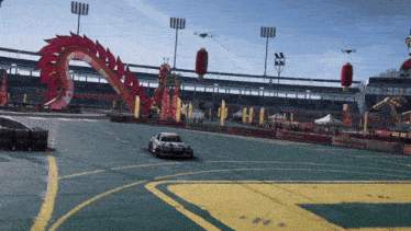 a race car is driving down a track with a dragon in the background and a sign that says ' lg ' on it