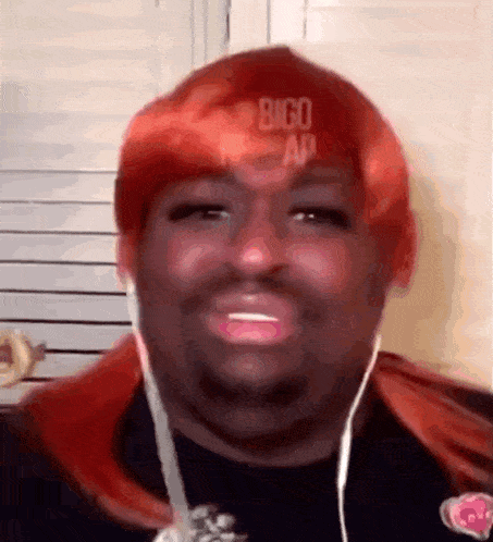 a man wearing headphones and a red wig with the word bigo on his hat