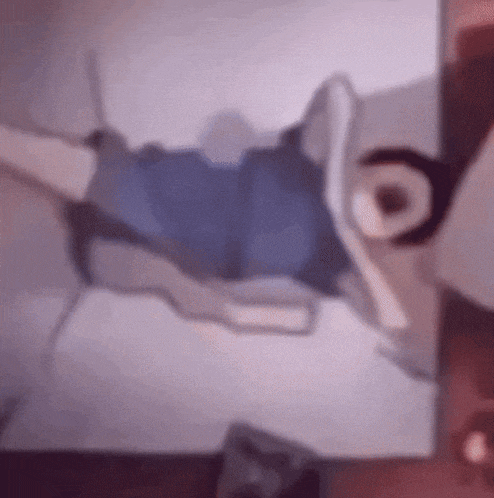 a blurry picture of a person laying on a bed