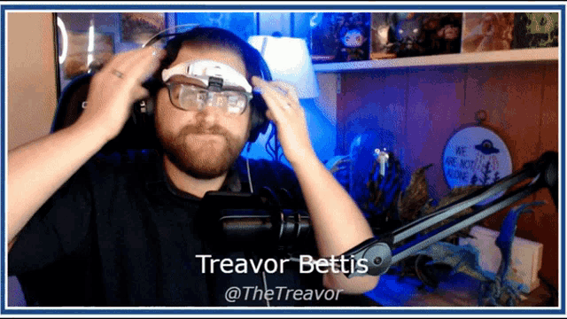 a man wearing headphones and glasses has the name treavor bettis on the bottom