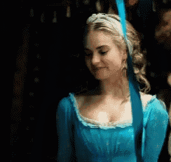 a woman in a blue dress is holding a blue ribbon in her hand