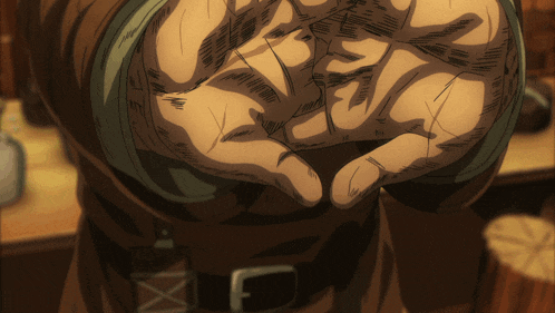 a close up of a person 's hand with a belt on
