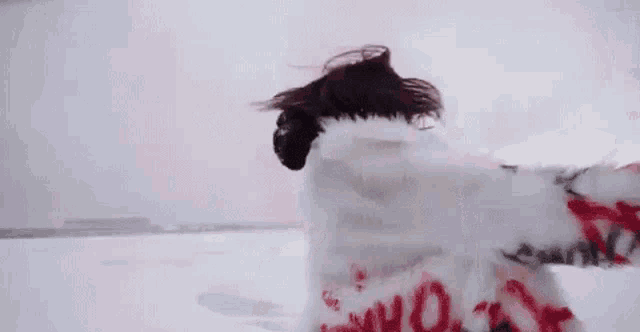 a woman is standing in the snow wearing a fur coat and a yellow jacket .