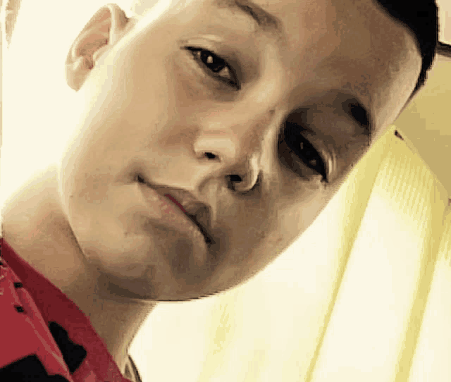 a close up of a young boy 's face with a serious look on his face