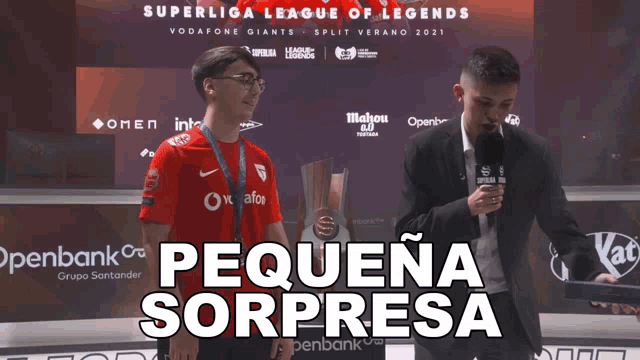 two men are standing in front of a superliga league of legends banner