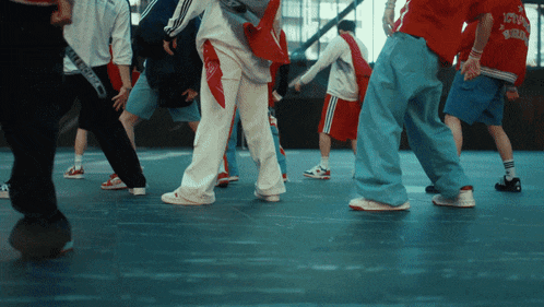 a group of people are dancing and one of them is wearing a red shirt that says ' york ' on it