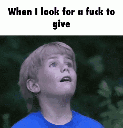 a boy in a blue shirt is looking up at the sky with the words `` when i look for a fuck to give '' .