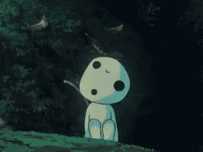 a cartoon character is sitting on top of a grass covered field in the dark .