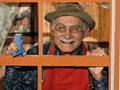 a man in a hat and apron is cleaning a window with a squeegee .