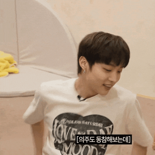 a person wearing a white shirt that says love saturday moon